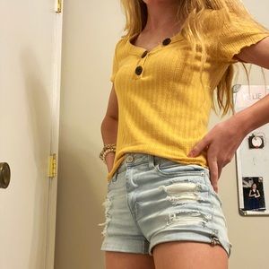 Yellow American eagle shirt with buttons.